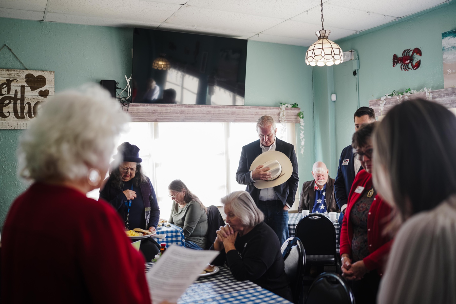 Bobby Williams standing respectfully during a community gathering.