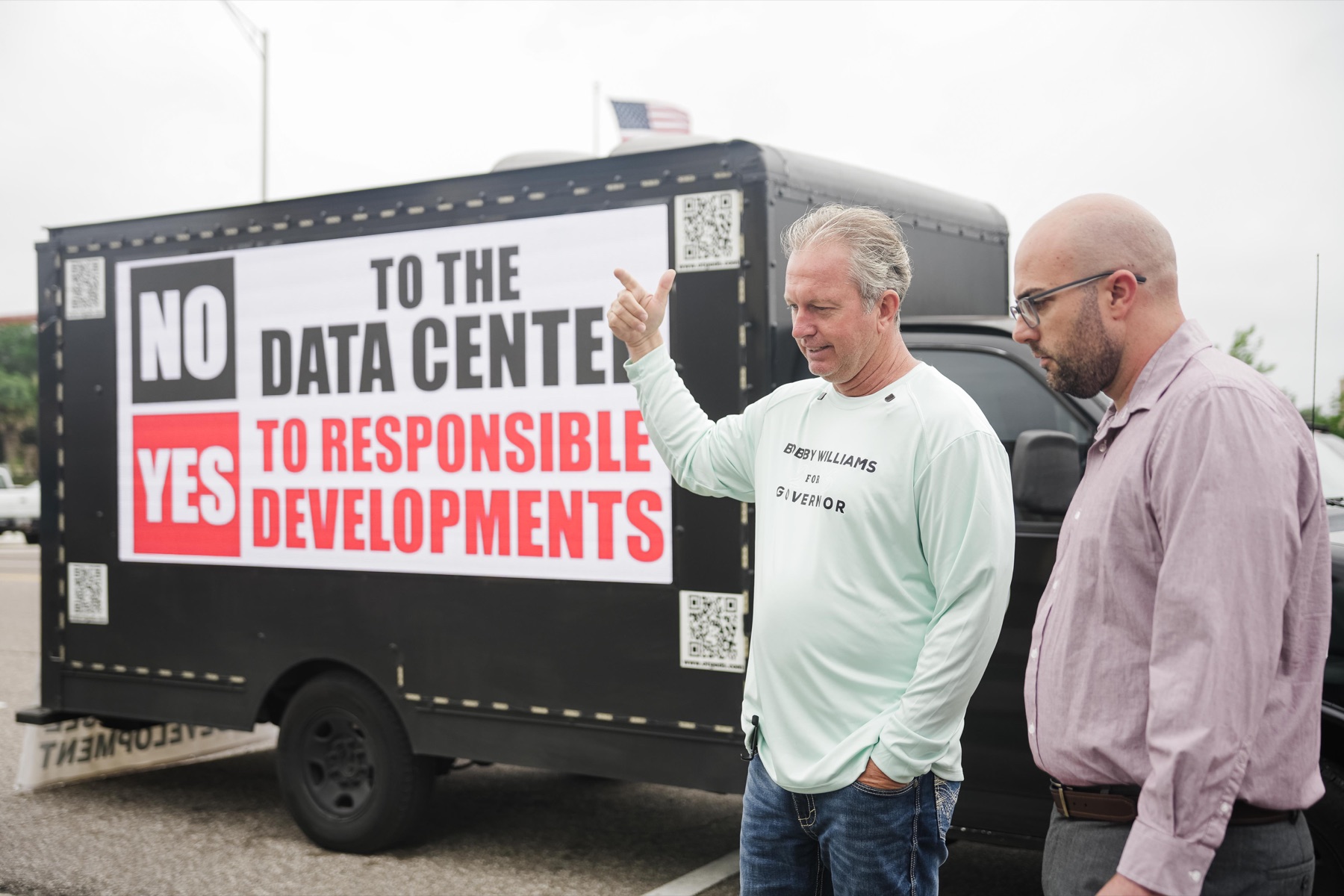 Bobby Williams near a sign opposing data centers and supporting responsible developments.